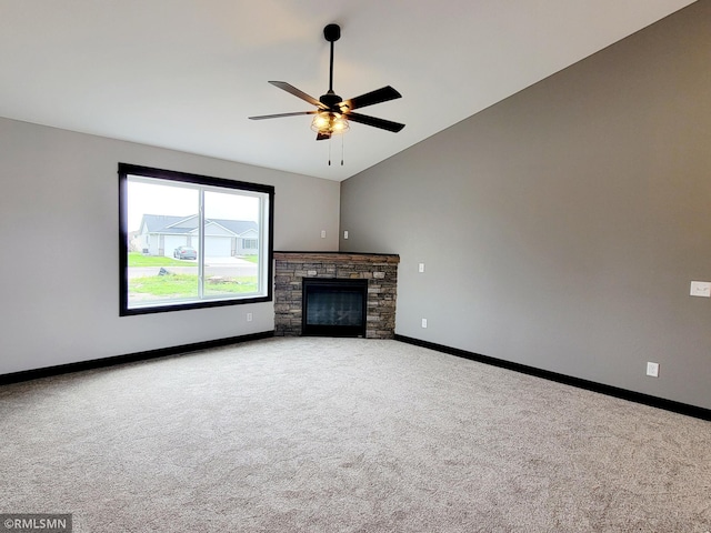 unfurnished living room featuring ceiling fan, carpet flooring, a fireplace, and vaulted ceiling