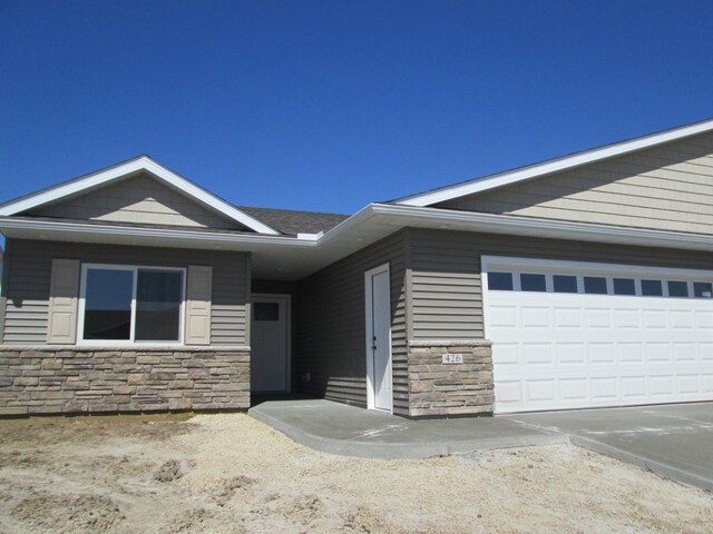 426 Fawn Run, Kenyon, MN 55946 - view of front of house with stone siding and concrete driveway