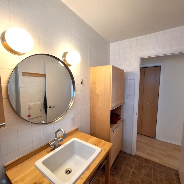 bathroom featuring vanity and tile walls