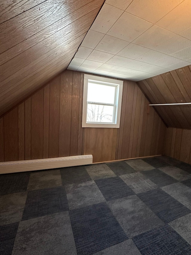 bonus room featuring carpet floors, wood walls, and lofted ceiling