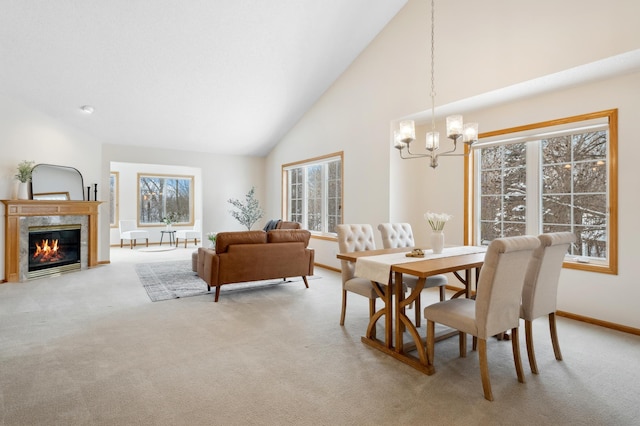11767 36th Cir NE, Saint Michael, MN 55376 - dining room with light carpet, a chandelier, high vaulted ceiling, baseboards, and a fireplace