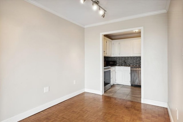 interior space with ornamental molding, a sink, and baseboards