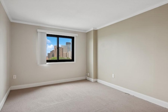 unfurnished room with ornamental molding, a view of city, light carpet, and baseboards