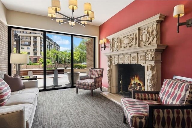 sitting room featuring a fireplace, carpet flooring, and a notable chandelier