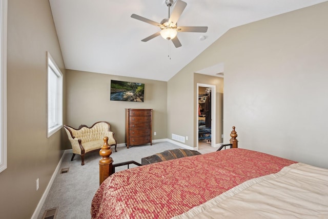 bedroom with lofted ceiling, a walk in closet, light colored carpet, a closet, and ceiling fan