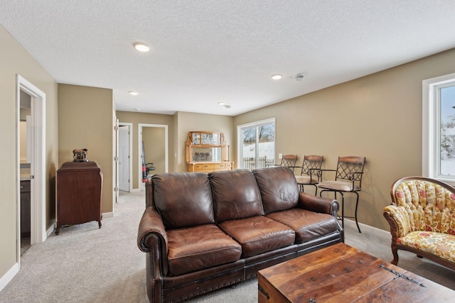 carpeted living room featuring a textured ceiling