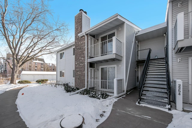 exterior space with a chimney and stairway