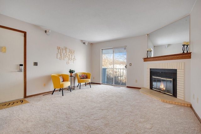 living area with carpet, a brick fireplace, and baseboards