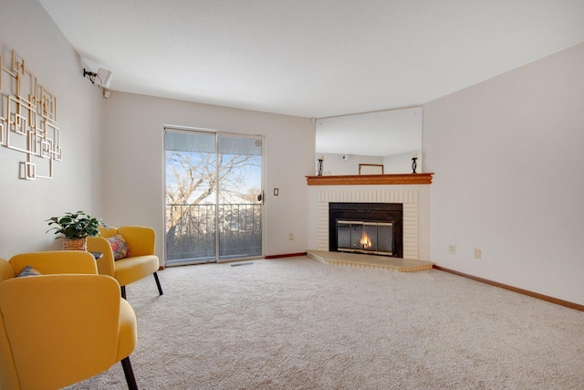 living area with carpet floors, a brick fireplace, visible vents, and baseboards