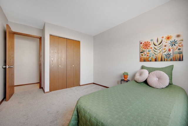 bedroom with carpet, baseboards, and a closet