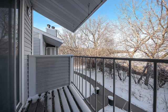 view of snow covered back of property