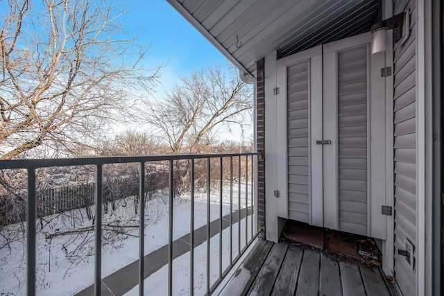 view of snow covered back of property