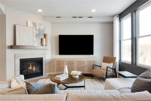 living room featuring visible vents and wood finished floors