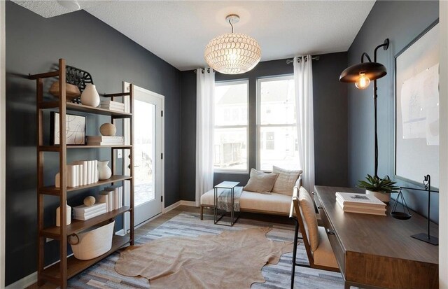 sitting room with baseboards and wood finished floors