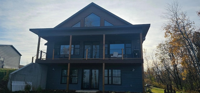 back of house with french doors and a balcony