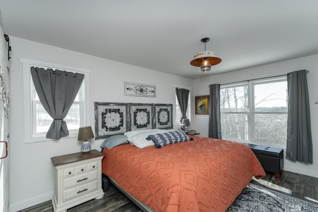 bedroom featuring baseboards and dark wood-style floors