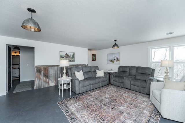 living room with a textured ceiling and finished concrete floors