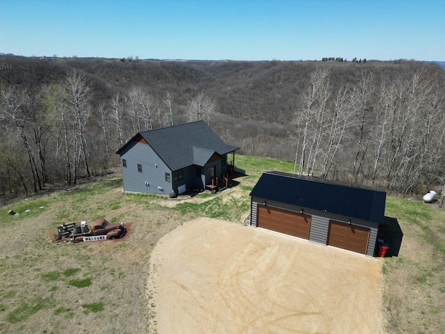 drone / aerial view featuring a view of trees