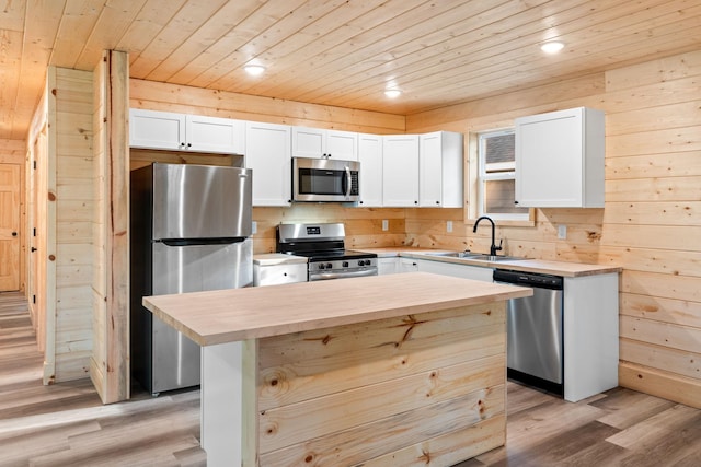 kitchen featuring sink, white cabinetry, wooden ceiling, appliances with stainless steel finishes, and a kitchen island