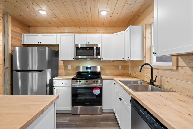 kitchen featuring butcher block counters, sink, white cabinetry, and stainless steel appliances