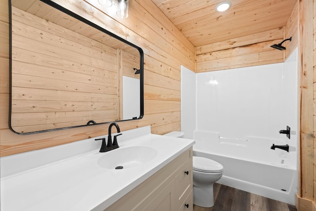 full bathroom featuring toilet, wood ceiling, vanity, wooden walls, and shower / bath combination