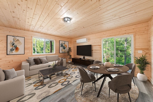 dining room with wood ceiling, a wall mounted air conditioner, wooden walls, and hardwood / wood-style floors