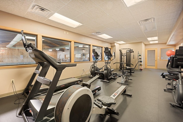 gym with a paneled ceiling