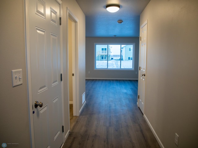 corridor with dark hardwood / wood-style floors