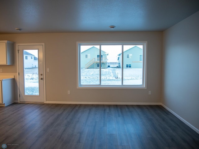 interior space with dark hardwood / wood-style flooring and a textured ceiling