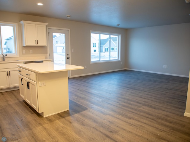 kitchen featuring white cabinetry, sink, dark hardwood / wood-style floors, and a kitchen island