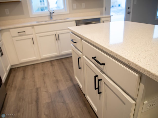 kitchen with white cabinetry, dark hardwood / wood-style floors, dishwashing machine, and sink