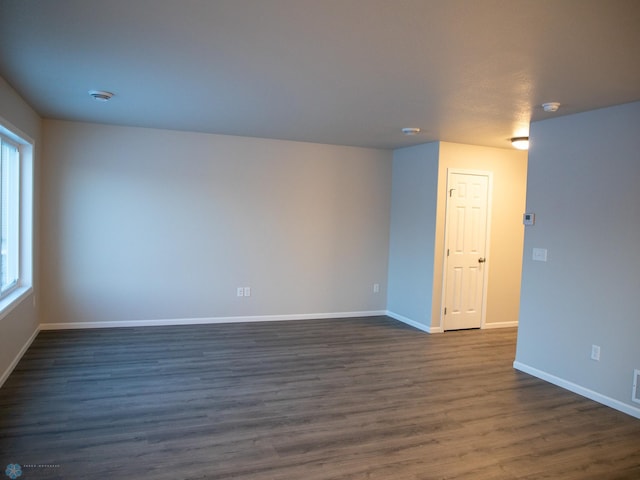 empty room with dark wood-type flooring