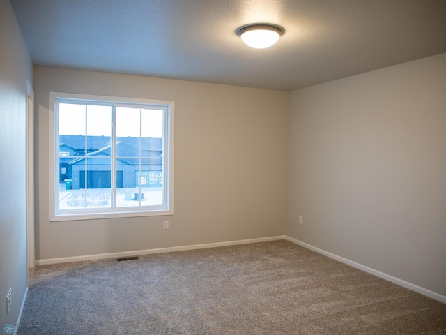 unfurnished room featuring a mountain view and carpet flooring