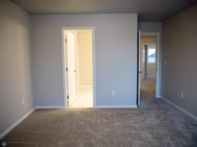 unfurnished bedroom featuring light colored carpet