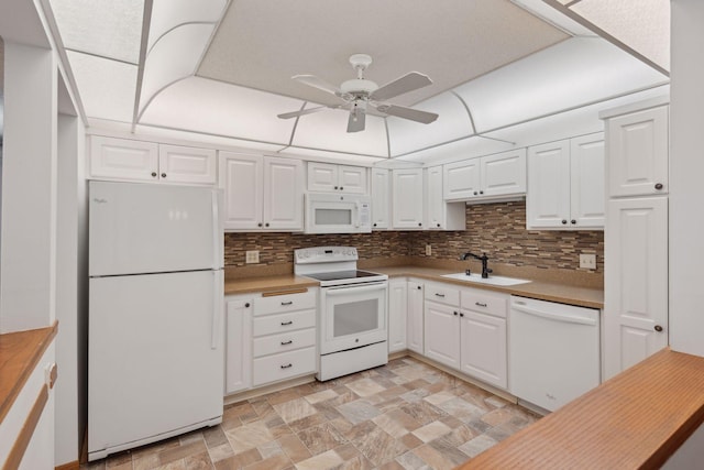 kitchen featuring white appliances, sink, backsplash, and white cabinets