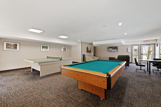 game room with pool table, dark colored carpet, and a textured ceiling