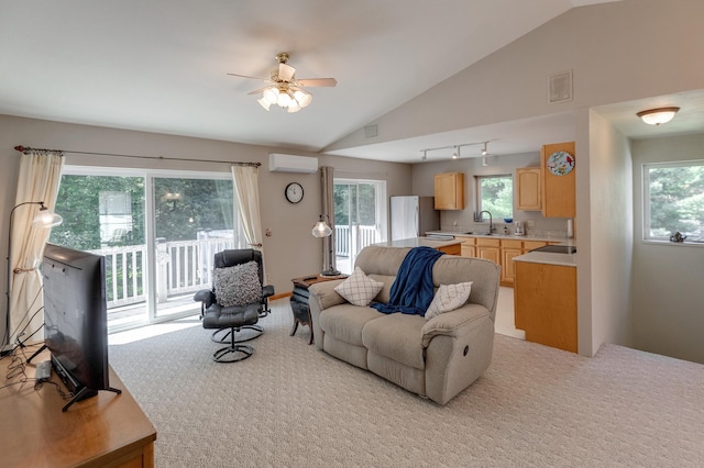 living room featuring light colored carpet, lofted ceiling, sink, and an AC wall unit