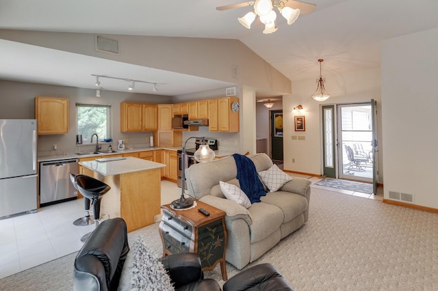 living room with lofted ceiling, sink, light colored carpet, ceiling fan, and track lighting