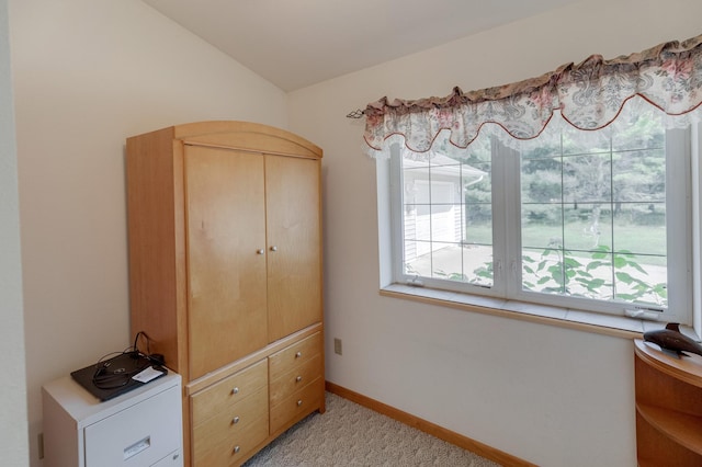 carpeted bedroom with lofted ceiling