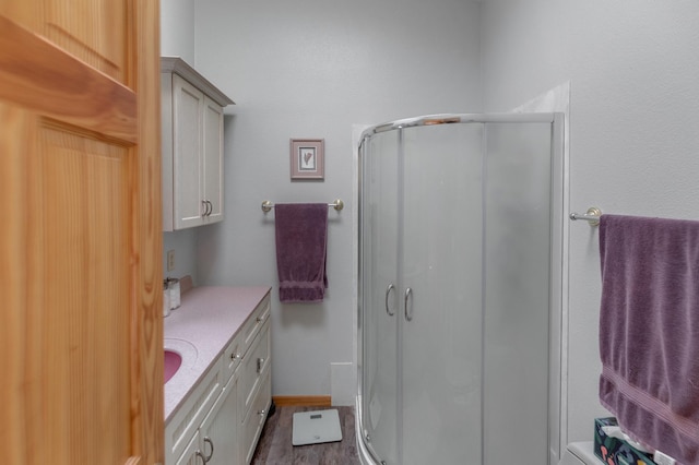 bathroom featuring vanity and an enclosed shower