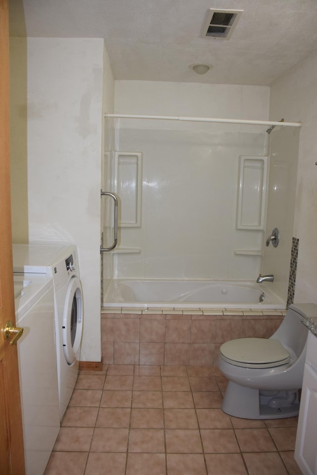 full bathroom featuring washer / clothes dryer, vanity, and tiled shower / bath combo