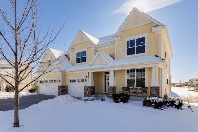 craftsman inspired home featuring a porch and a garage