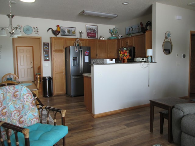 1902 Tiffany Cove Ln SW, Rochester, MN 55902 - kitchen featuring stainless steel fridge, dark wood finished floors, a peninsula, fridge, and brown cabinets