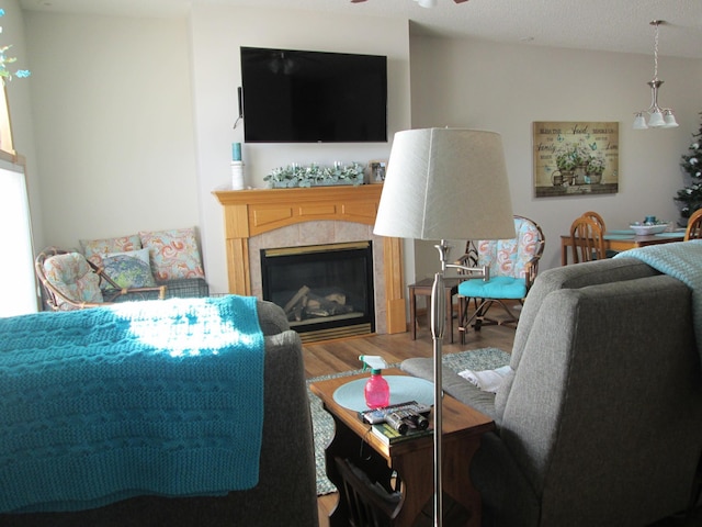 1902 Tiffany Cove Ln SW, Rochester, MN 55902 - living area featuring wood finished floors, a ceiling fan, and a tile fireplace