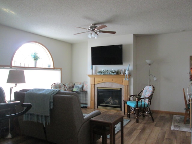 1902 Tiffany Cove Ln SW, Rochester, MN 55902 - living area featuring wood finished floors, ceiling fan, a textured ceiling, and a tile fireplace