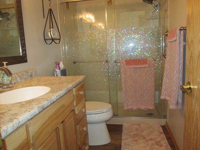 1902 Tiffany Cove Ln SW, Rochester, MN 55902 - bathroom with a stall shower, vanity, wood finished floors, and toilet