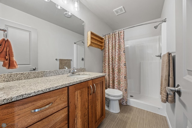 bathroom with vanity, a shower with curtain, and toilet