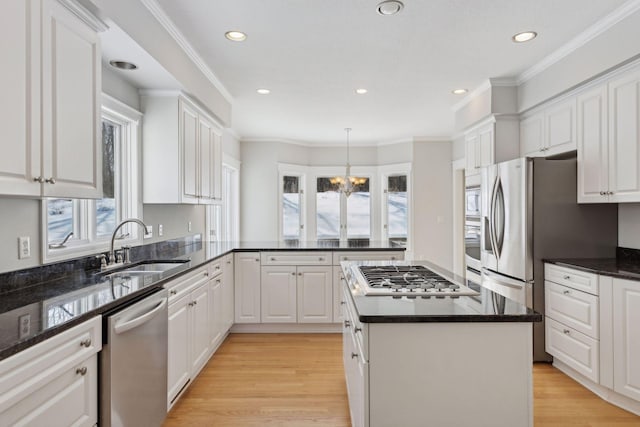 kitchen featuring stainless steel appliances, white cabinetry, and a sink