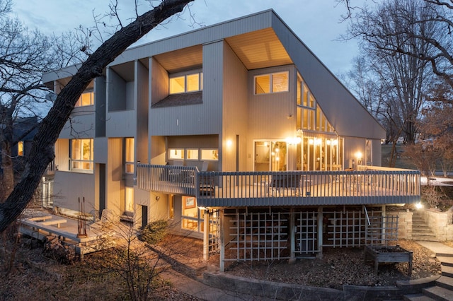 back of house featuring a wooden deck