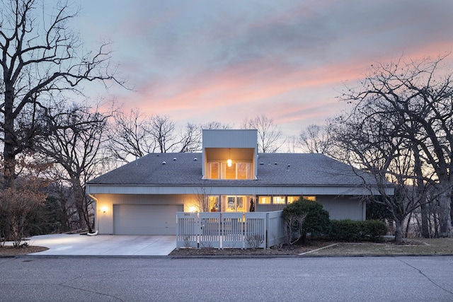 view of front of property with concrete driveway and an attached garage